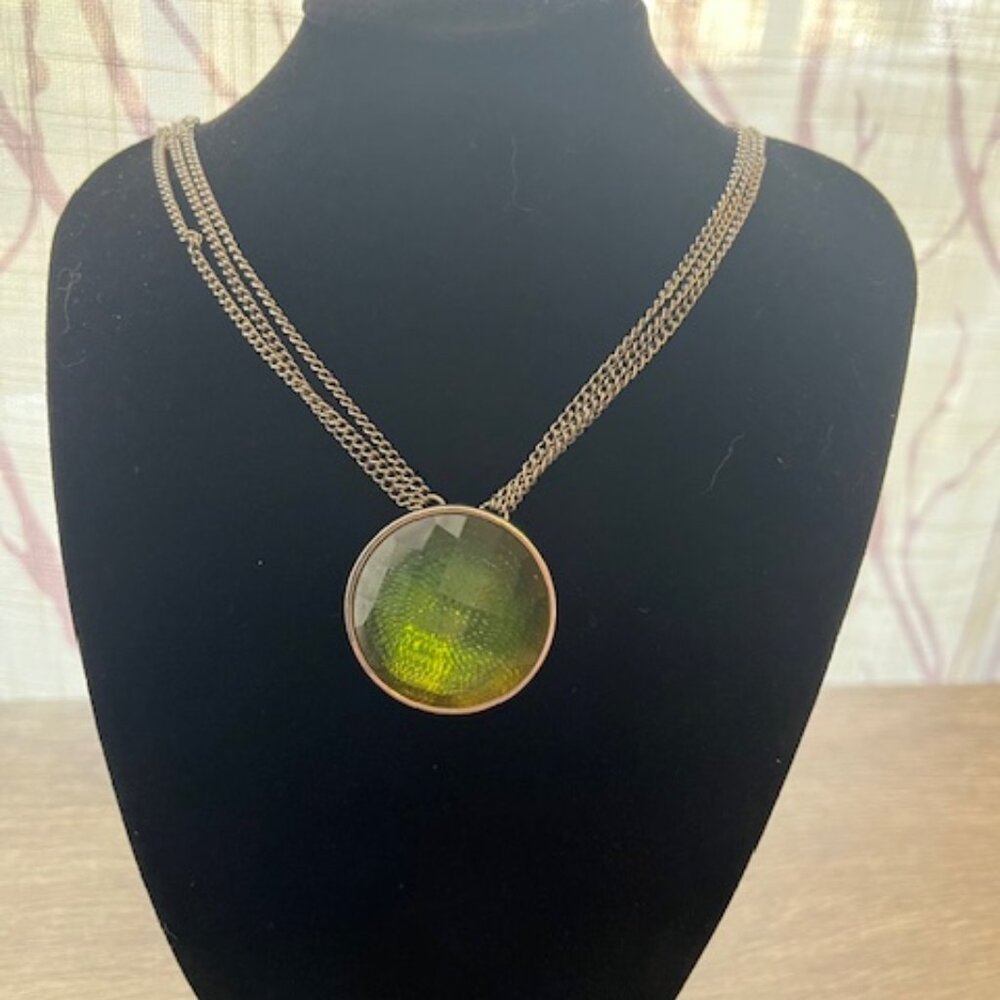 Multi Strand necklace with a large faceted green gemstone pendant